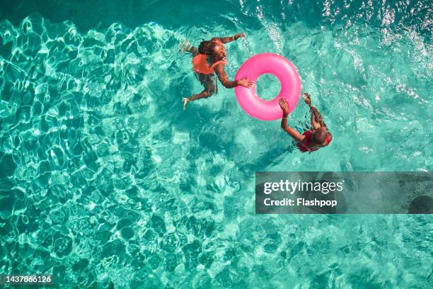 aerial view point of mother and daughter swimming together. - aerial view people swimming pool stock pictures, royalty-free photos & images