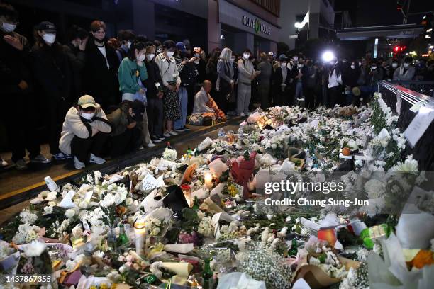 People pay tribute for the victims of the Halloween celebration stampede, on the street near the scene on October 31, 2022 in Seoul, South Korea. One...