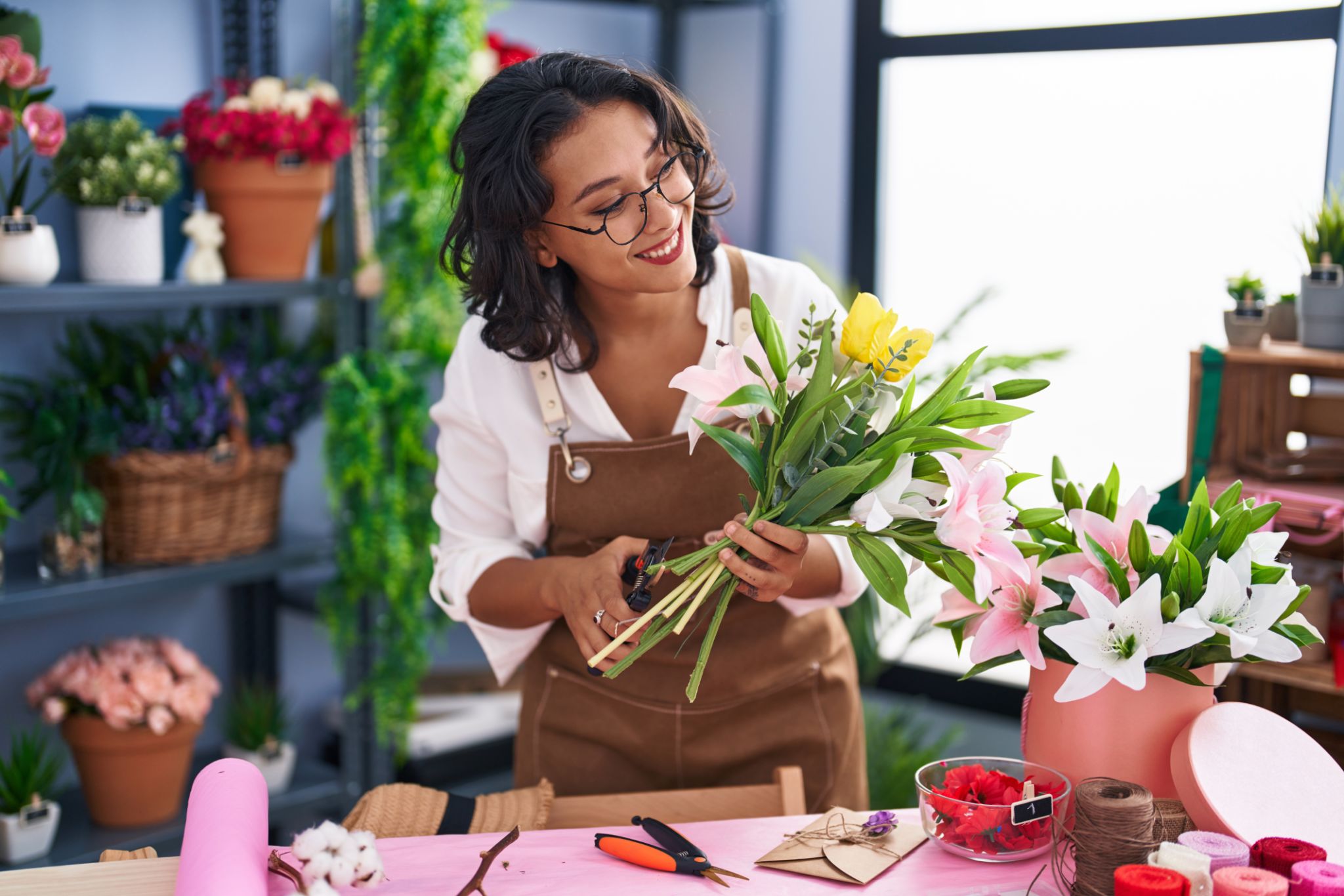 Young beautiful hispanic woman florist make bouquet of flowers at flower shop Young beautiful hispanic woman florist make bouquet of flowers at flower shop