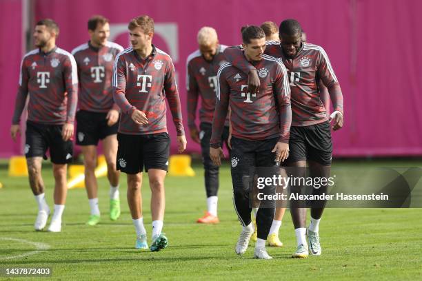 Marcel Sabitzer of FC Bayern München talk to his team mate Dayto Upamecano during a training session at Saebener Strasse training ground ahead of...