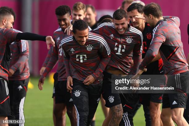 Lucas Hernandez of FC Bayern München reacts with his team mate Leroy Sane during a training session at Saebener Strasse training ground ahead of...