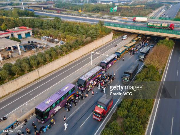 Foxconn employees take shuttle buses to head home on October 30, 2022 in Zhengzhou, Henan Province of China. Shuttle buses have been arranged by...