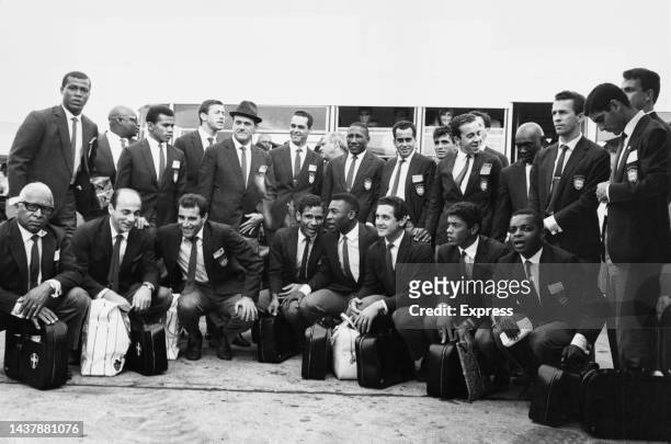 Brazilian footballer Pele and his teammates, wearing matching blazers, pose for a team portrait after their arrival at Heathrow Airport in London,...