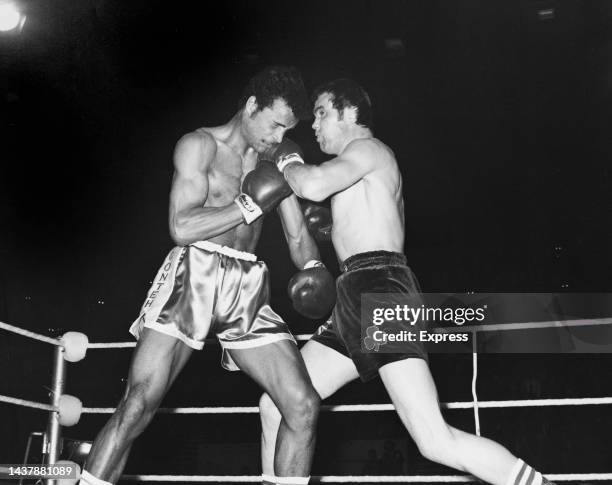 British boxer J is hit with a left jab from British boxer Chris Finnegan during their light heavyweight title fight, staged at the Empire Pool,...