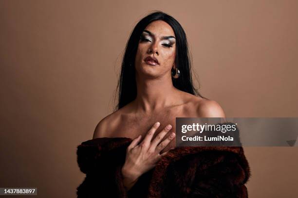 beauty, fashion and lgbtq with a man in studio on a brown background for empowerment. inclusion and proud with a feminine male drag queen posing for acceptance and style - costume beige stock pictures, royalty-free photos & images