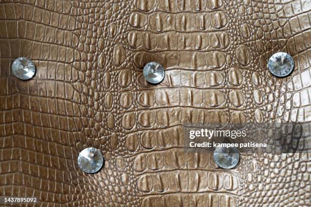 textured background of genuine leather in crocodile skin pattern - wrinkled skin texture foto e immagini stock