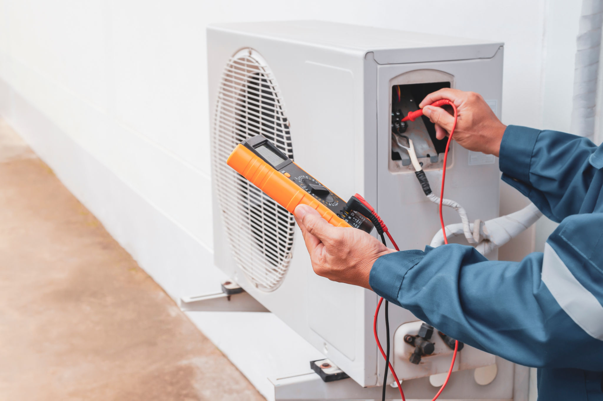 Air conditioner technician repairing central air conditioning system with outdoor tools Air conditioner technician repairing central air conditioning system with outdoor tools