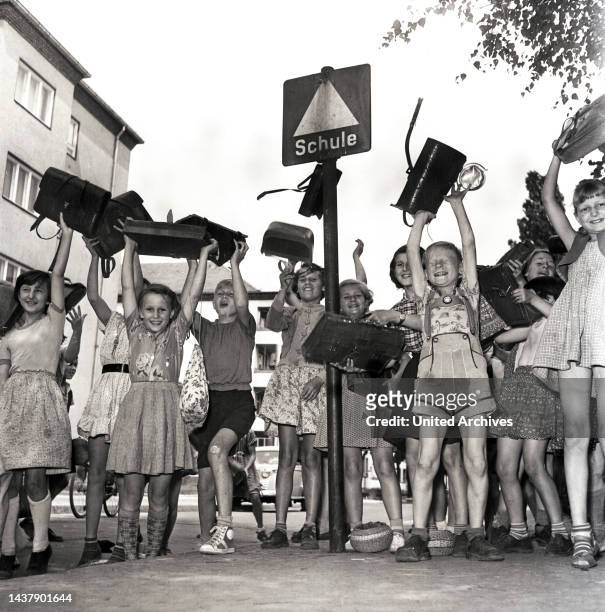 Hinein in die großen Ferien - Kinder stürmen am letzten Schultag aus dem Schulgebäude ins Freie, in die Sommerferien, Berlin, Deutschland 1955.