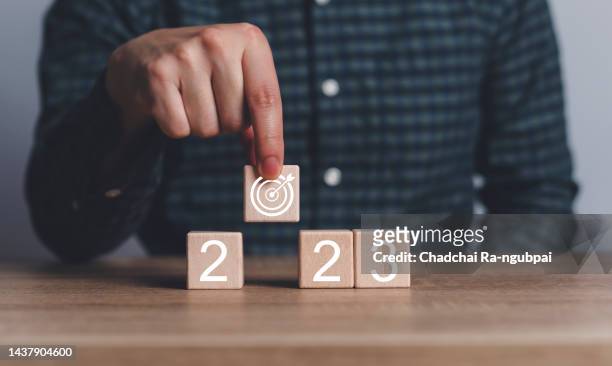 2023 business development to success and growing growth concept.business strategy, action plan, goal and target, hand stack woods block step on table with icon about business strategy and action plan. - the first time stock pictures, royalty-free photos & images