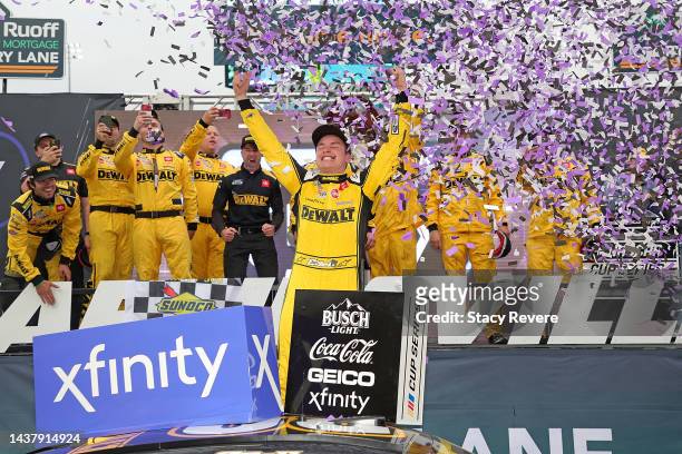 Christopher Bell, driver of the DeWalt Toyota, celebrates in victory lane after winning the NASCAR Cup Series Xfinity 500 at Martinsville Speedway on...