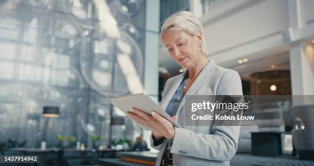 business, tablet and woman in leadership in an office alone checking company sales, financial or revenue growth. corporate, finance and successful senior executive management or ceo networking online - mature business woman digital tablet corporate professional stockfoto's en -beelden