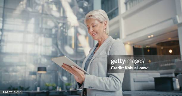 tablet, success and profit business woman check e commerce software app, website information or company asset management in lobby. happy corporate professional boss on digital technology reading news - hyatt hotels corp hotel ahead of earnings figures stockfoto's en -beelden