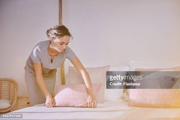 hotel inspector checking the pillows on a bed - room service stock pictures, royalty-free photos & images