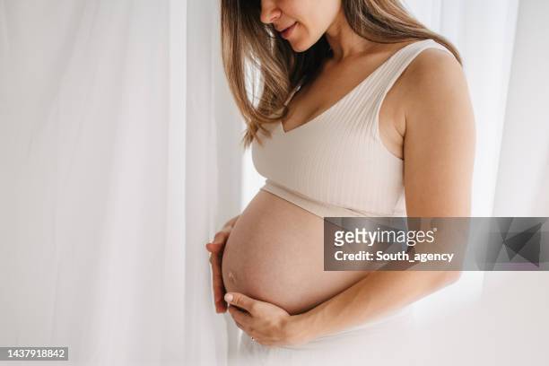 pregnant woman - women abdomen stock pictures, royalty-free photos & images