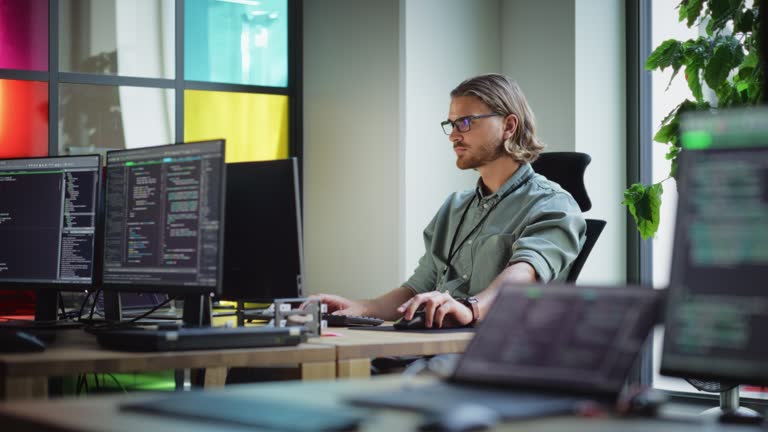 Male Data Scientist Coding on Desktop Computer in Creative Office Space ...
