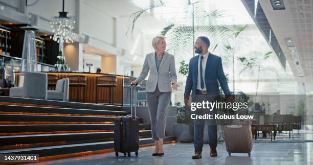 travel, airport and partnership with business people and luggage for communication, leadership or collaboration. vip, corporate and networking with ceo and employee for journey, flight and management - business traveller stockfoto's en -beelden