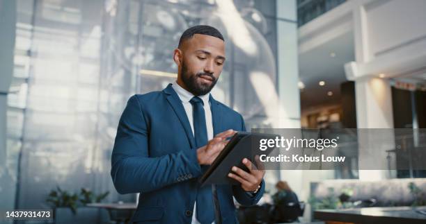 hotel, manager and man on a digital tablet for booking, planning and accommodation management while working at front desk. black man, concierge and hospitality by male doing online task at reception - hotel occupation stock pictures, royalty-free photos & images