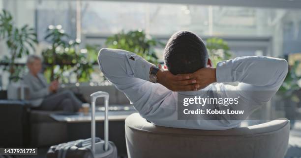 travel, airport and businessman relax in lounge before airplane flight for company, corporate or executive job work. calm mindset, luggage and back view of ceo sleeping in hotel lobby before journey - gate stockfoto's en -beelden