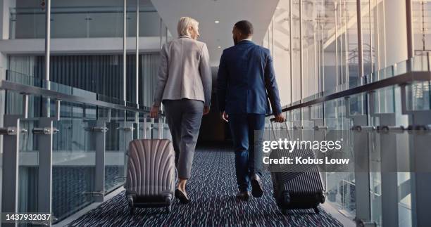 business people, travel and luggage at airport terminal to board flight for work seminar, trip or conference abroad. corporate man and woman with suitcase boarding for international business workshop - business travel stock pictures, royalty-free photos & images