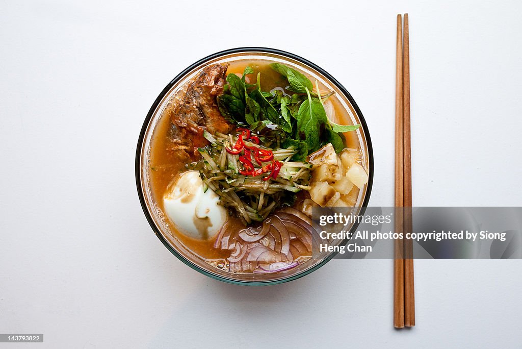 Malaysian noodles laksa in bowl and chopsticks