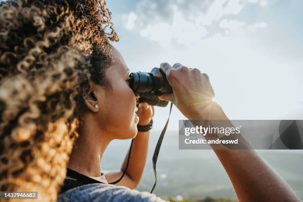 backpacker woman using binoculars - binoculars stock pictures, royalty-free photos & images