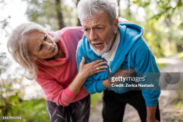 senior man suffering heart attack - heart attack stockfoto's en -beelden