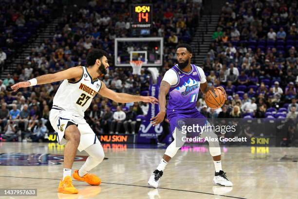 Mike Conley of the Utah Jazz drives in front of Jamal Murray of the Denver Nuggets during a game at Vivint Arena on October 19, 2022 in Salt Lake...