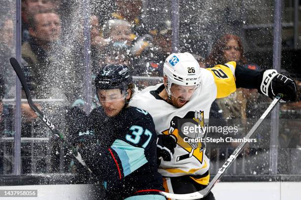 Yanni Gourde of the Seattle Kraken and Jeff Petry of the Pittsburgh Penguins collide during the second period of the game at Climate Pledge Arena on...