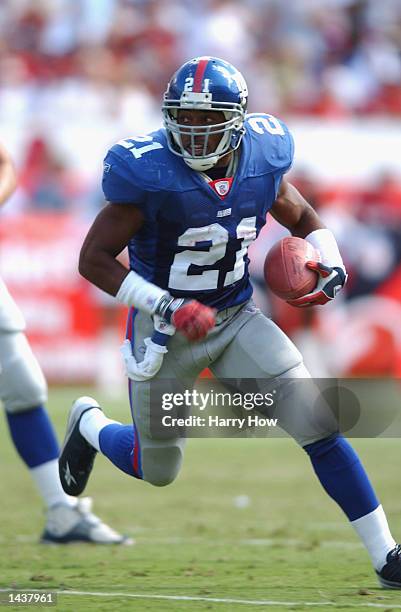 Tiki barber of the New York Giants runs with the ball against the Phoenix Cardinals during the second quarter on September 29, 2002 at Sun Devil...