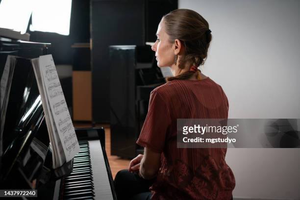female pianist preparing for a concert - backstage concert stock pictures, royalty-free photos & images
