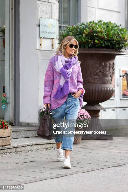 Influencer Gitta Banko wearing a pink and purple knitted pullover by Simone Bruns, a purple and pastel lavender scarf by Pur Schoen, light blue...