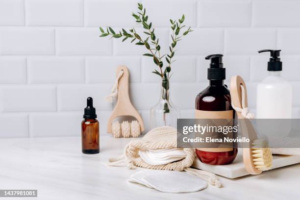 skin care and body care beauty gift set lotion, gel, shampoo, serum, massage brushes, cotton pads for makeup remover. - bathroom closeup stockfoto's en -beelden