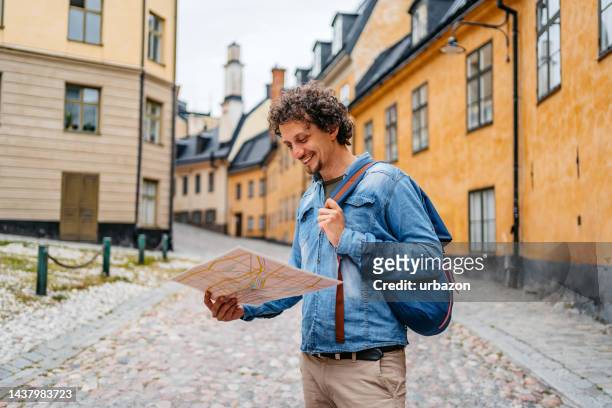 young tourist reading a map in the city of stockholm - scandinavia map stock pictures, royalty-free photos & images