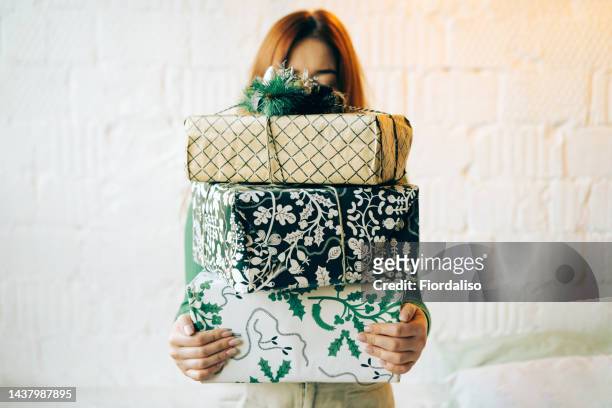portrait of a long-haired red-haired woman with gifts packed in white and green boxes. christmas holidays, meeting the new year. subscription boxes - commercial activity stock pictures, royalty-free photos & images