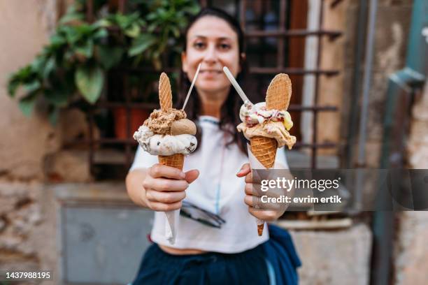 woman holding two cones of organic italian ice cream - italian icecream stock pictures, royalty-free photos & images