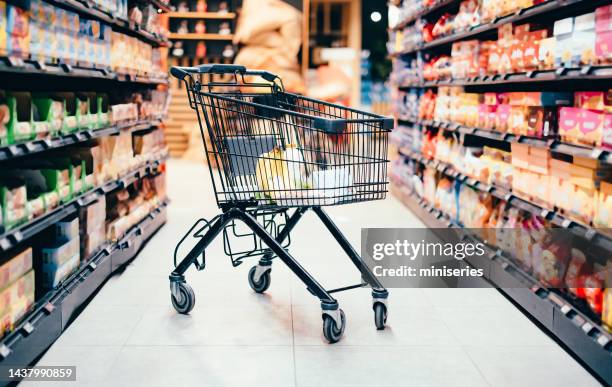 abandoned shopping cart with groceries - shopping cart groceries stock pictures, royalty-free photos & images