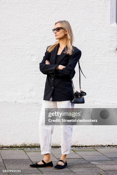Model and influencer Marlies-Pia Pfeiffhofer, wearing a black balzer by Mango, a white jeans by Mango, black ballerinas by Miu Miu, a black bag by...