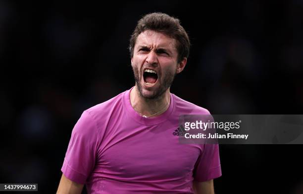Gilles Simon of France celebrates taking the second set against Andy Murray of Great Britain in the first round during Day One of the Rolex Paris...