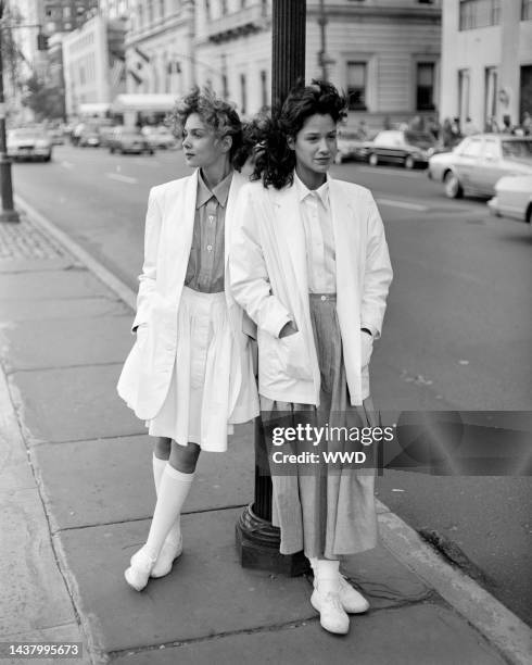 Models on the street near Central Park wearing outfits from the Norma Kamali spring 1983 ready to wear collection for the Jones Apparel Group, the...