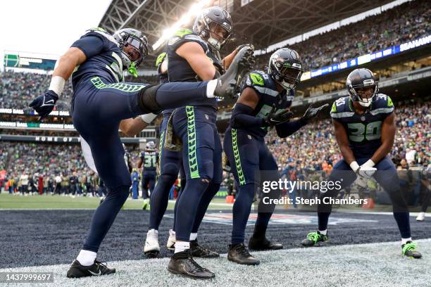Members of the Seattle Seahawks celebrate a turnover during the fourth quarter against the New York Giants at Lumen Field on October 30, 2022 in...