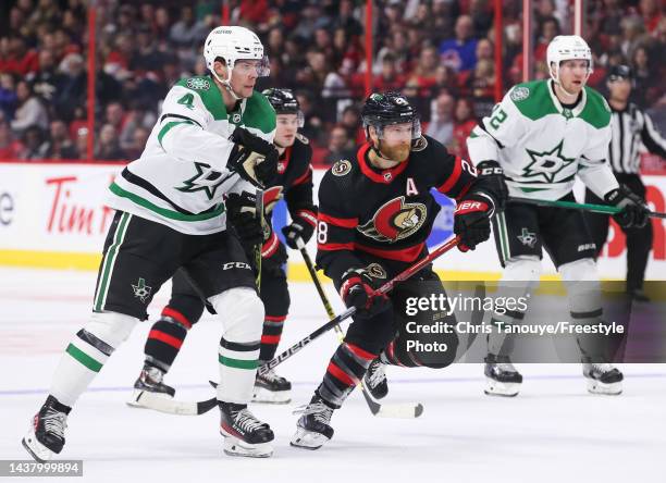 Miro Heiskanen of the Dallas Stars and Claude Giroux of the Ottawa Senators skate for the puck at Canadian Tire Centre on October 24, 2022 in Ottawa,...
