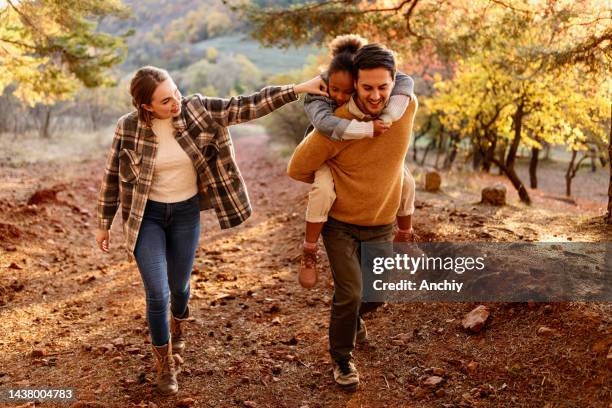 young family going on a hike in the forest - blended family stockfoto's en -beelden