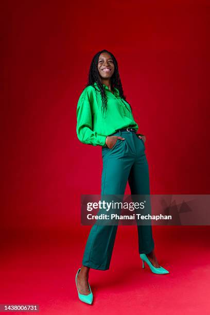 beautiful woman wearing green outfit - portrait young colour background cool stock-fotos und bilder