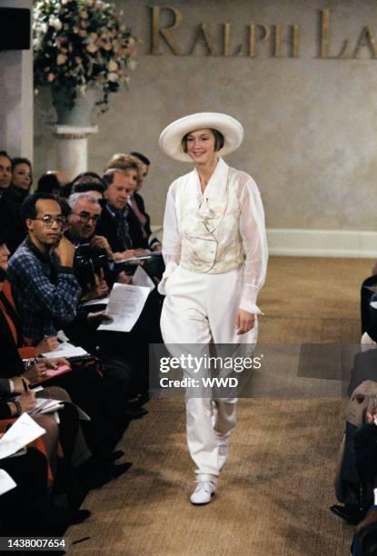 Model wearing white jodhpurs and vest over a sheer blouse from Ralph Lauren's spring/summer 1989 RTW collection on the runway