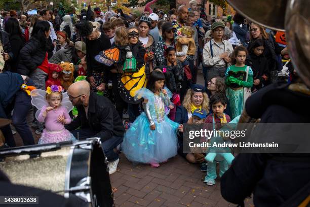 Parents accompany their young children for an early evening celebration of Halloween on October 31, 2022 in the Cobble Hill neighborhood of Brooklyn,...