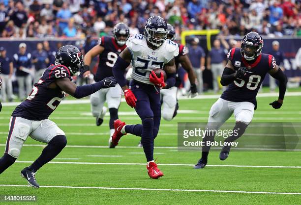 Derrick Henry of the Tennessee Titans rushes past Desmond King II of the Houston Texans and Christian Kirksey at NRG Stadium on October 30, 2022 in...