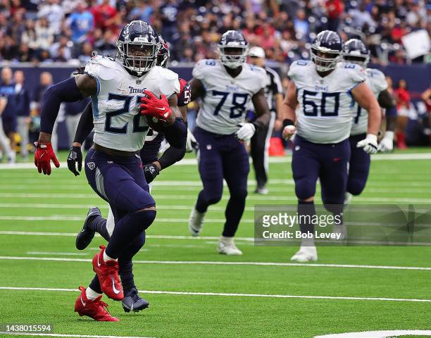 Derrick Henry of the Tennessee Titans runs past Desmond King II of the Houston Texans and Christian Kirksey for a touchdown at NRG Stadium on October...