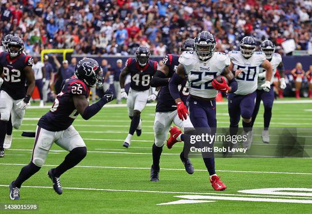 Derrick Henry of the Tennessee Titans runs past Desmond King II of the Houston Texans and Christian Kirksey for a touchdown at NRG Stadium on October...