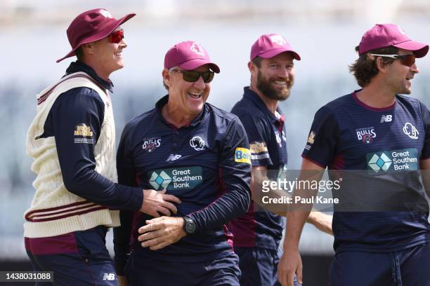 Andy Bichel, assitantant Queensland coach looks on after being thrown into the air by players during the Sheffield Shield match between Western...
