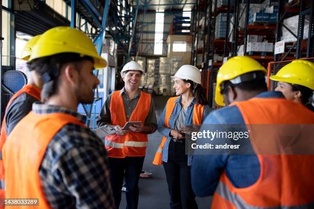 staff meeting at a distribution warehouse - warehouse worker stock pictures, royalty-free photos & images